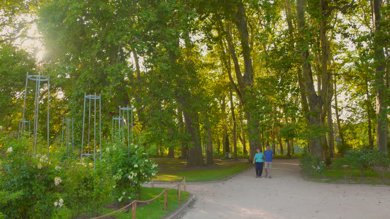 People walking through the greenery in the city park of the Golden Head, Lyon, France