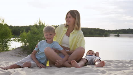 mother with her kids on the beach