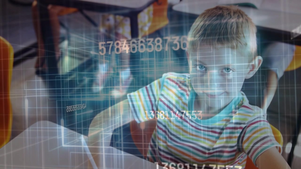 Boy reaching white tablet in class, activating numeric hologram, looking up, smiling while learning