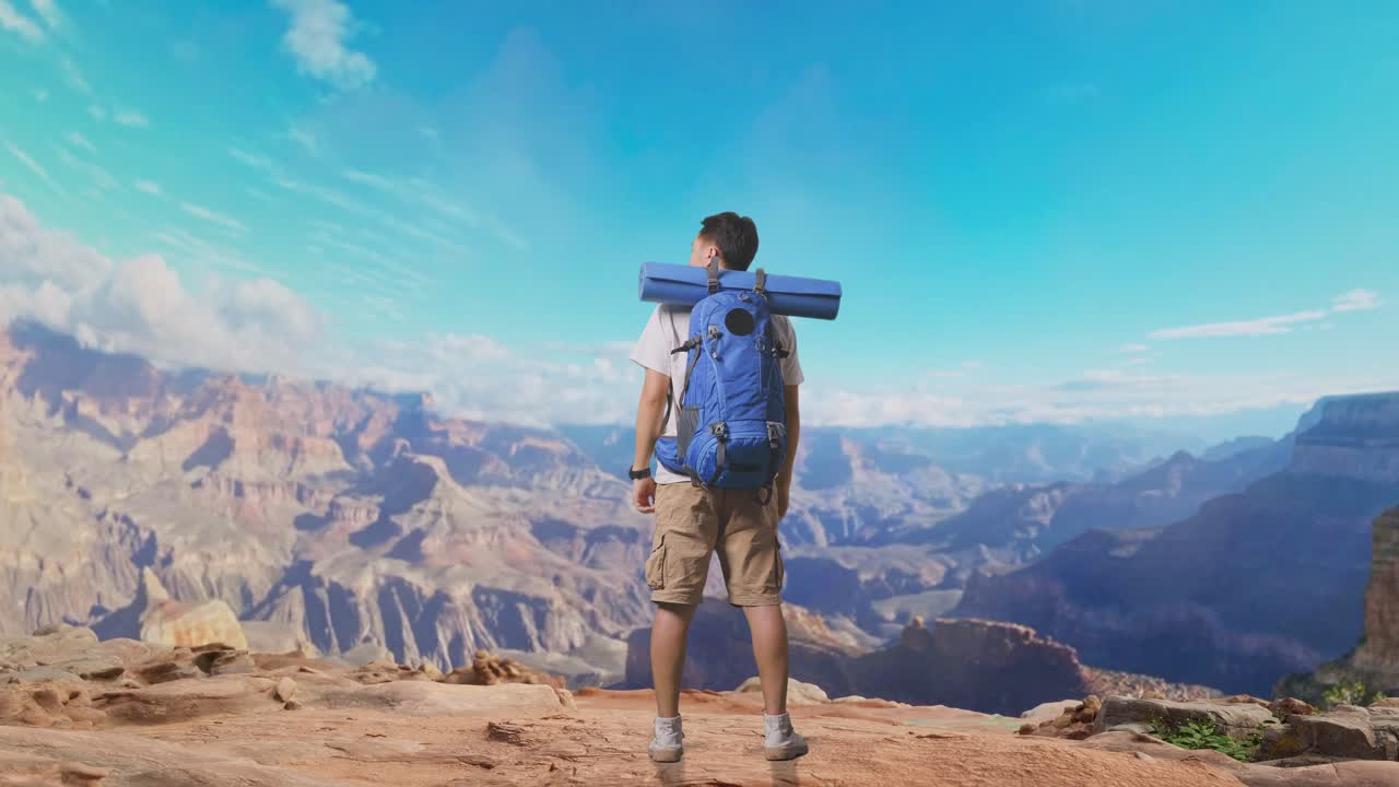 Full Body Back View Of A Male Hiker With Mountaineering Backpack Looking Around While Traveling At The Top Of Mountain