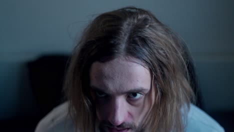 a drug addict wakes up dazed with a hangover after a night of partying - close up