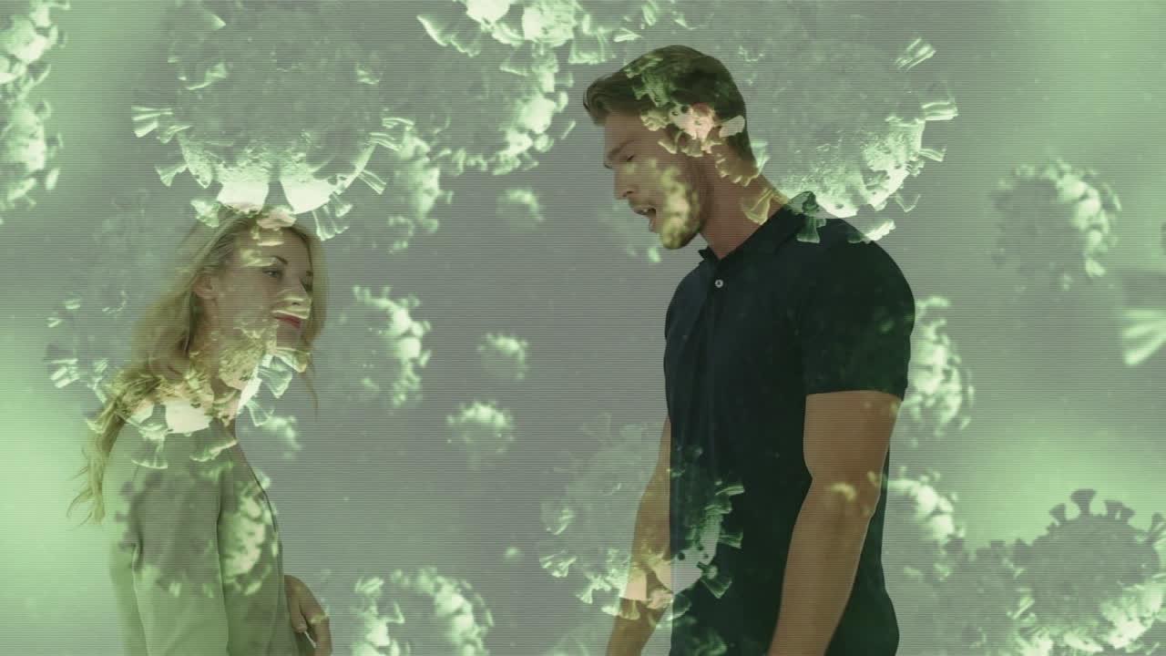 video compuesto digital de células de covid-19 moviéndose contra una pareja que lucha en el fondo