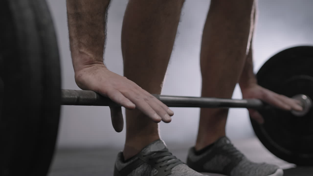 Unrecognizable Powerlifter Lifting Barbell