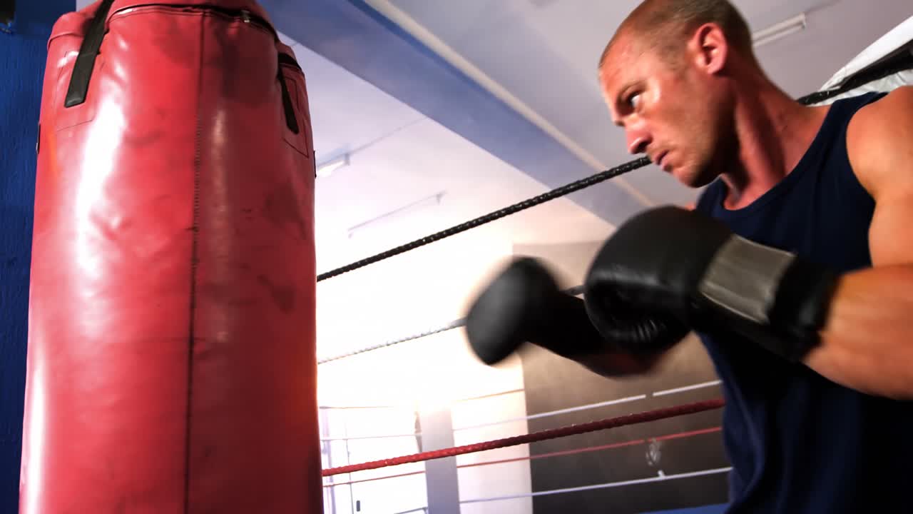 Boxer practicing boxing with punching bag