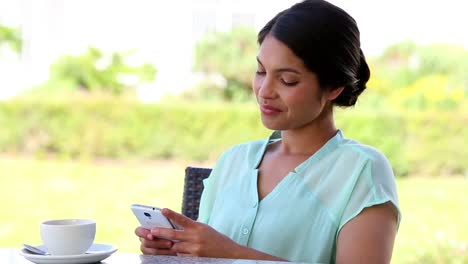 Businesswoman-having-coffee-while-texting