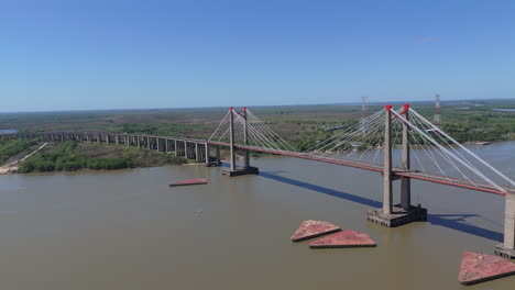 the justo josé de urquiza bridge crossing the paraná guazú river on a sunny day, aerial view