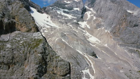 aerial-landscape-of-steep-mountain-face-toward-summit-of-Dolomite-on-sunny-summer-day