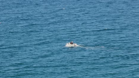 Tracking-shot-of-fishermen-heading-out-to-sea-on-a-small-fishing-trawler-in-newquay