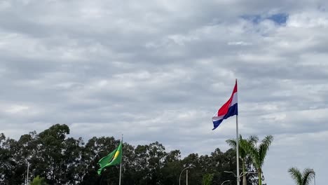 Brazil-and-Paraguay-flags-waving-on-a-cloudy-day