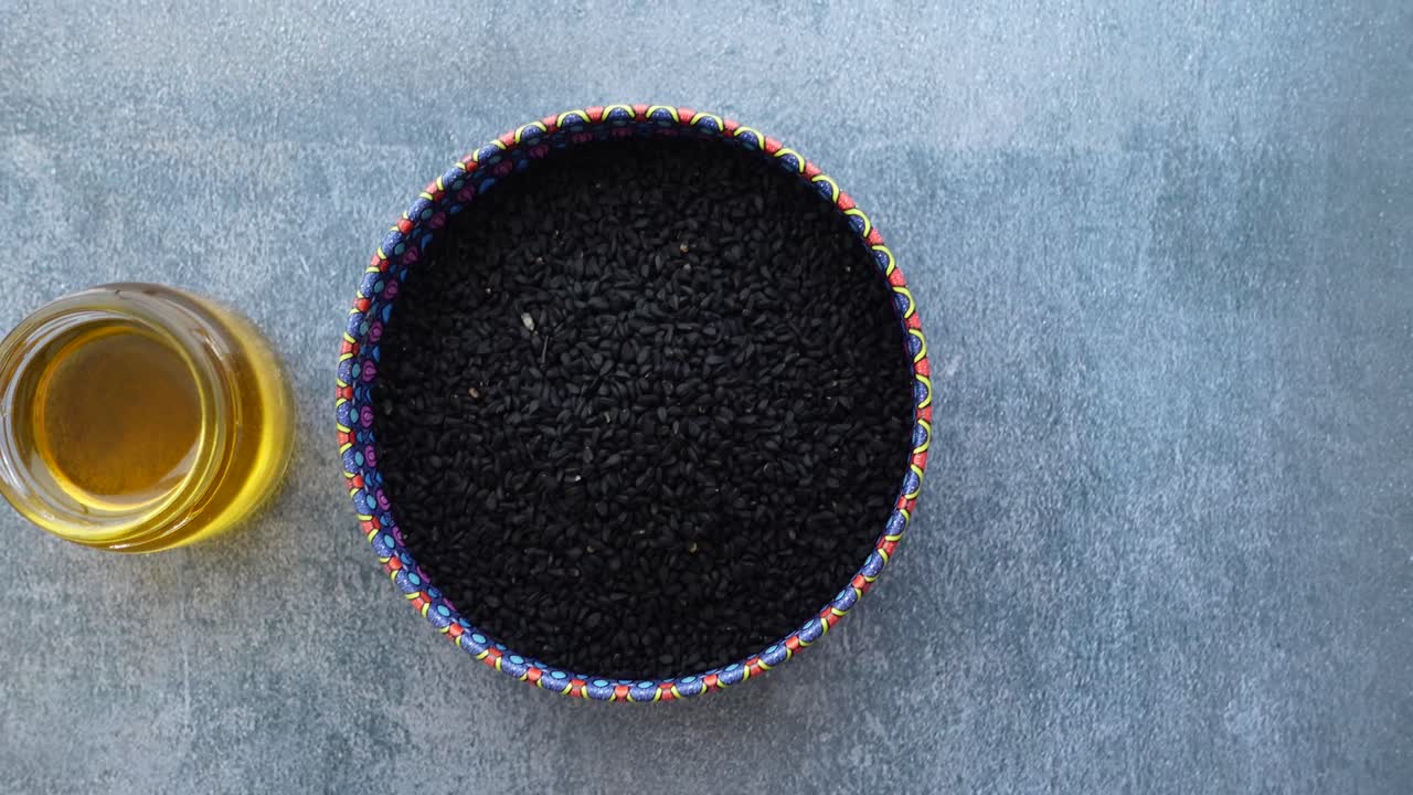 Black Cumin Seeds and Oil Still Life