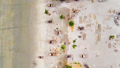 Drop-down-view-of-Bangladeshi-village-people-repairing-fishing-boats-on-Kuakata-sea-beach