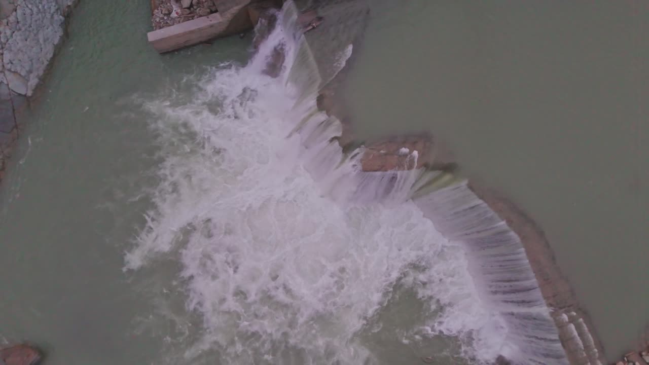 A breathtaking waterfall cascading between lush green mountains, showcasing the beauty of nature, flowing water, and the peaceful scenery of a pristine natural environment