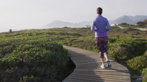 caucasian woman enjoying free time by sea on sunny day running path