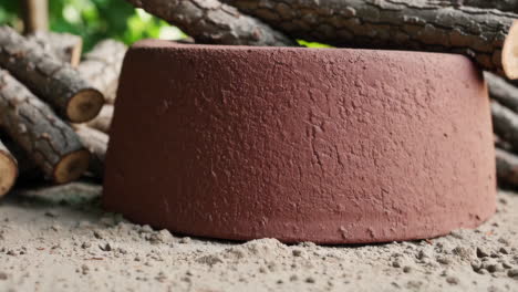 brown concrete fire pit with logs