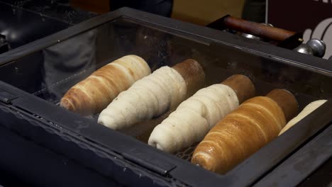 close shot of trdelnik, a spit cake, cooking in a shop at prague