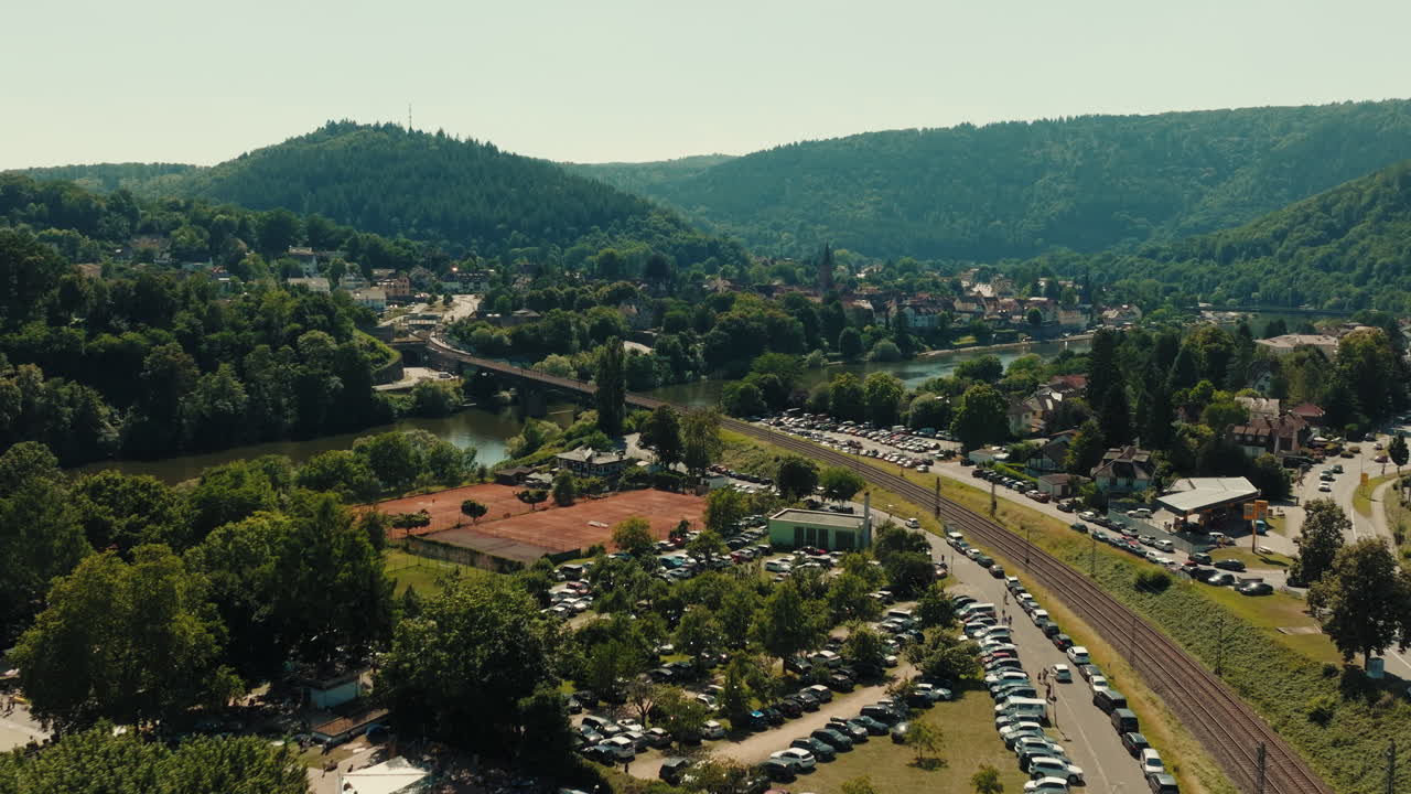 Descriptive aerial establishing shot of the German city of Odenwald in Bavaria with beautiful mountain range, valleys and rural urban building settlements