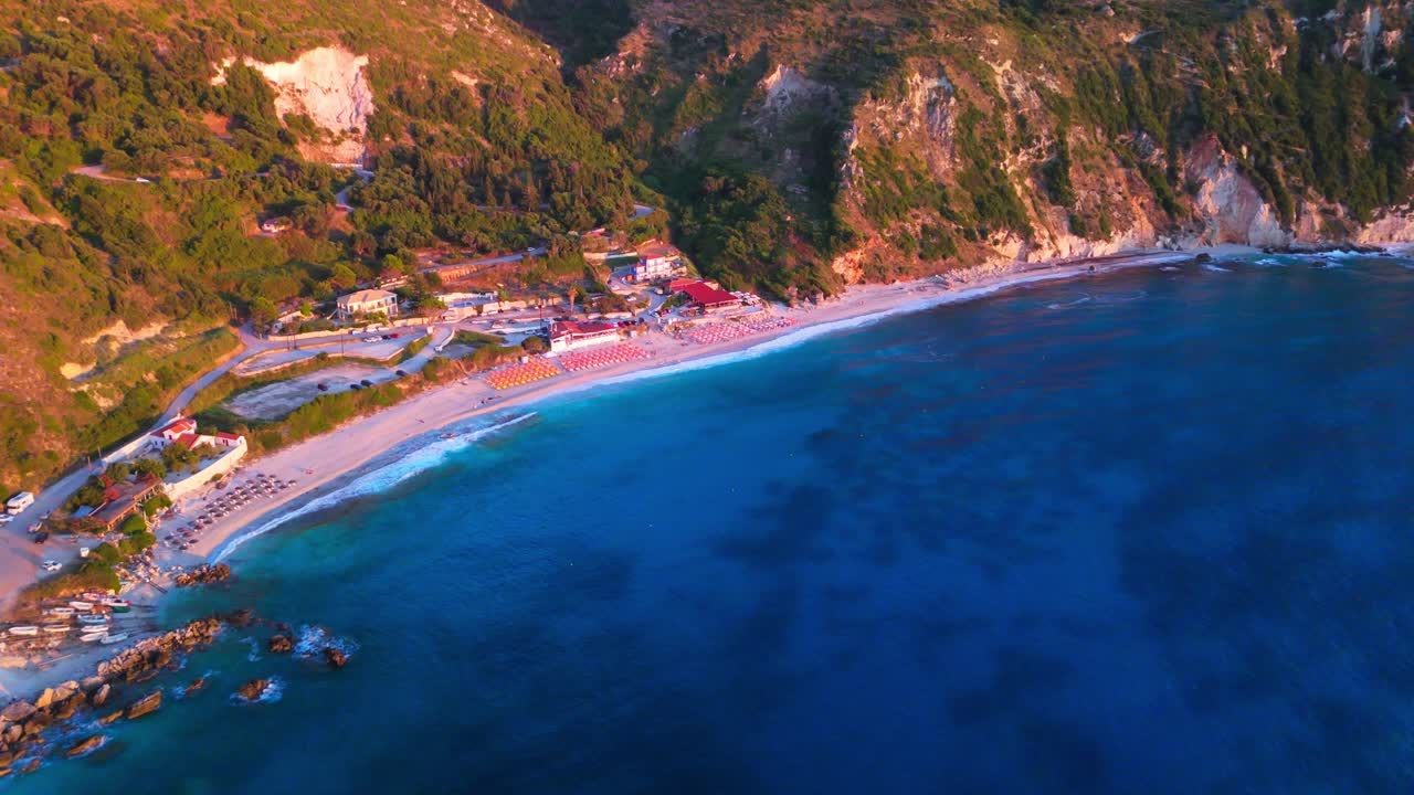 Stunning aerial footage showcasing Petani Beach on the island of Kefalonia, Greece. Captured in 4K, this clip features the turquoise Ionian Sea, dramatic white limestone cliffs, and the golden beach