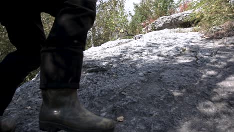 person hiking up a rocky trail