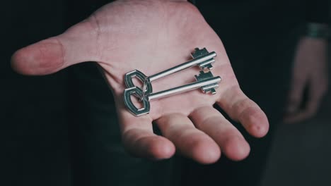 keys are hidden in a fist of male hand