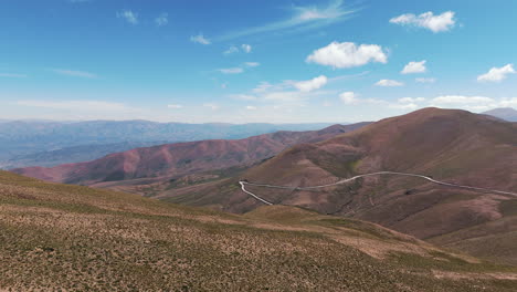 Aerial-establishing-shot-of-a-windy-road-running-through-the-Andean-Mountains