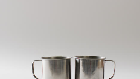 two metal camping mugs and copy space on white background