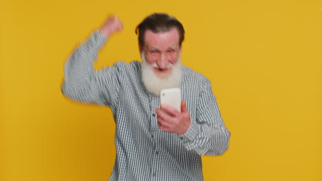 happy excited winner old man use smartphone celebrating success winning play game good lottery news