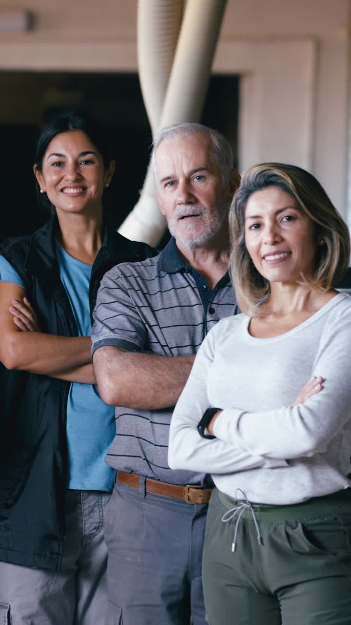 Confident Team of Workers Posing in a Workshop Environment