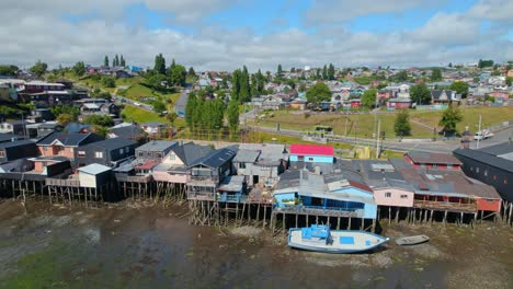 drone flyover panning over famous colorful stilt homes, castro chiloe island, 4k chile