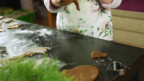 child’s hands kneading gingerbread dough in preparation for festive christmas cookies