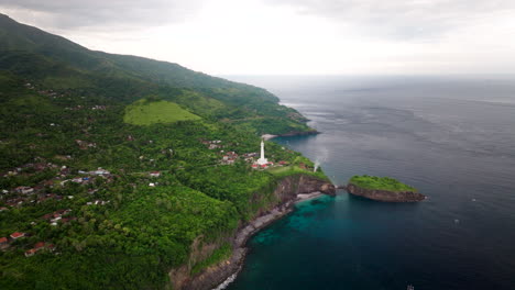 aerial view of gili selang lighthouse overlooking island and bay in bali, indonesia