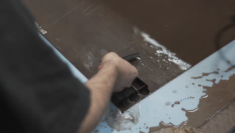 taking out cutted stainless steel knife patterns in knives factory, close up