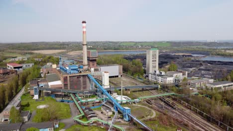 Old-coal-mine-elevator-and-piles-of-slag-behind-in-Karvina-on-a-sunny-day