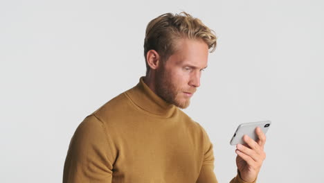 focused man watching video on phone