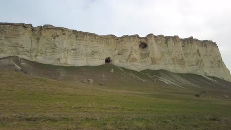 Experience-the-grandeur-of-Crimea-as-you-immerse-in-the-sight-of-horses-grazing-by-the-white-cliff-in-this-video,-embodying-natural-beauty-and-tranquility