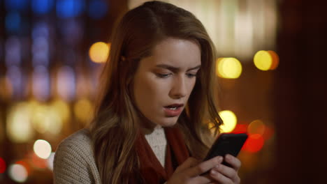 Upset girl face reading sms phone outdoors. Shocked woman getting message phone