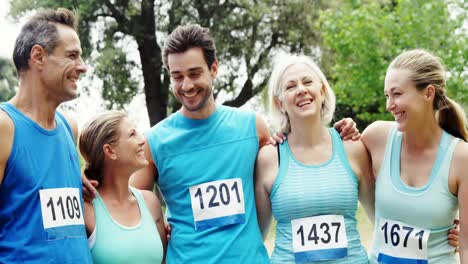 Athletic-family-standing-together-in-the-park