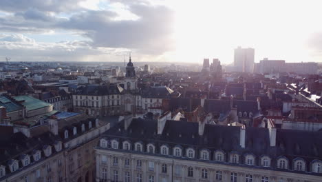 aerial rising in old city center of rennes, city hall at golden hour, france