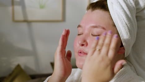 young woman massaging her face