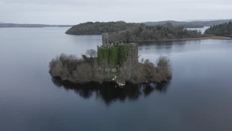 aerial view ruins of mcdermott castle on castle island, lough key in roscommon county, ireland - drone shot