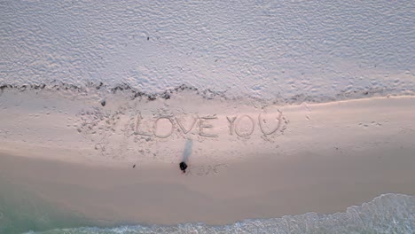 write letters i love you turquoise water gently washing white sand beach with palm trees of koh rong island. best aerial view flight speed ramp hyper motion time lapse