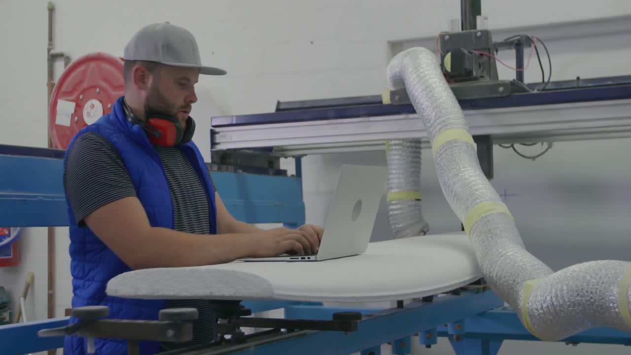 Male surfboard maker in his workshop
