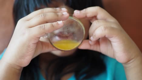 girl drinking orange juice