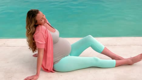 pregnant woman sitting near the pool