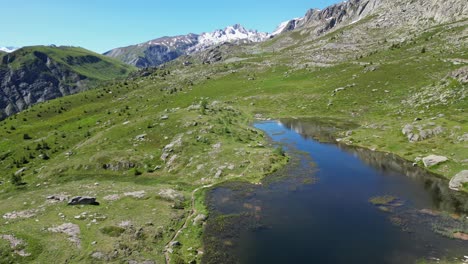 mountain lake lac guichard in french alps, france - aerial dolly forward