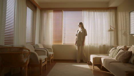 woman standing by the window in a living room