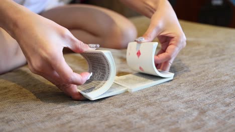 hands skillfully shuffle a deck of playing cards