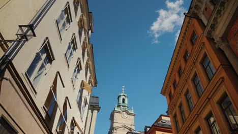 st nicholas (storkyrkan) bell tower in stockholm view through a narrow street with old houses 4k vid