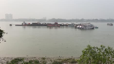 rows of ships and small fishing boats piled up in hooghly river near babu ghat in kolkata