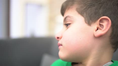 emotional child in front of the tv watching a sad film