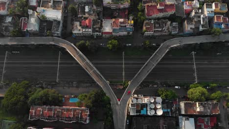 Aerial-top-down-of-old-rusted-bridge-with-driving-cars-in-poor-region-of-India